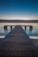 Fototapeta premium Amazing sunrise over the pier at baltic sea. Summer background