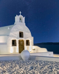Small Greek orthodox church at night in Oia village, Santorini greek island in Greece, Europe.