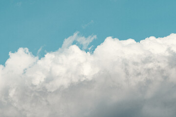 Teal blue sky with clouds