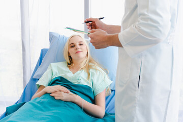 The doctor visiting a girl patient in the hospital