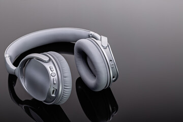 Fototapeta na wymiar Bluetooth wireless headphones. Modern devices for listening to music. Studio shot, copy space.