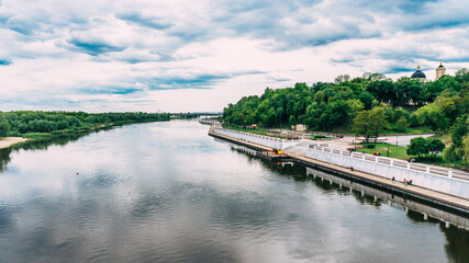 Fototapeta premium Beautiful view from the bridge to the Sozh River and the embankment in a green park. Gomel. Belarus