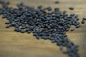 black sesame seeds on wood background
