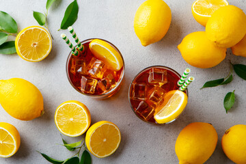 Ice tea with fresh lemons. Grey background. Close up. Top view.