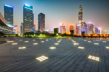 night view of empty brick floor front of Panoramic skyline and buildings