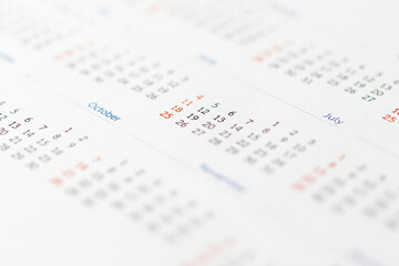 Close up calendar page dates abstract blurred background business planning appointment meeting concept