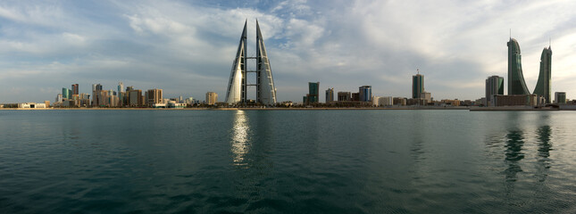 Naklejka premium MANAMA, BAHRAIN - JANUARY 30: Bahrain skyline with iconic buildings, the Bahrain World Trade Center and the Financial Harbour during sunset on January 30, 2018, Manama, Bahrain