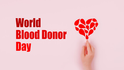 World Blood Donor Day background with copy space. Blood donor day campaign for donation charity concept with red drops heart and hands. Giving blood saves lives