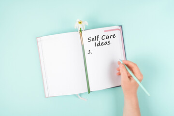Self Care, wellbeing ideas, holistic set of self-care activities concept with open notebook, flower narcissus.