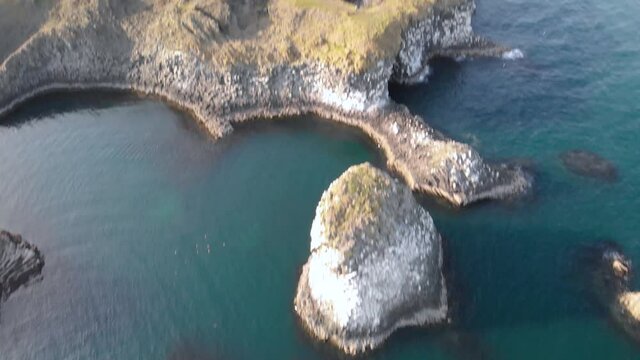 Revealing shot of a small fishing village on the West coast of Iceland called Arnarstapi