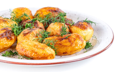 Fried fresh potatos and dill on a plate isolated on a white background