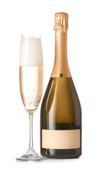 Bottle and glass of tasty champagne on white background