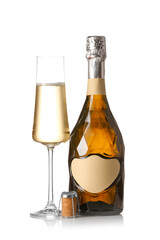 Bottle and glass of tasty champagne on white background