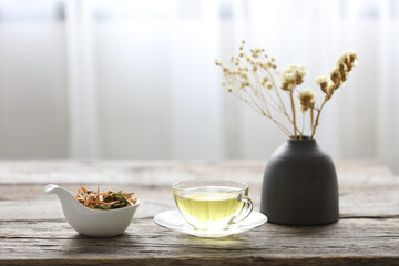 A cup of Lemongrass and Pandanus leaf herb with dry flower in clay pot 