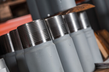 Circular precision stainless steel industrial machine parts arranged in rows on pallet. Steel...