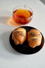 buns and tea are on the table in the kitchen