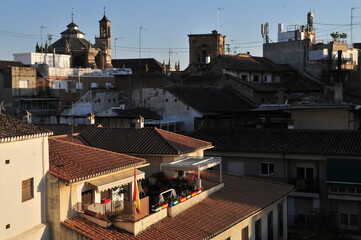 Spanish and Andalusian flags on a terrace in lower Albaicín Moorish quarter, Granada, Spain. Cathedral in background