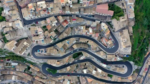 Aerial view of the old town of Ragusa Ibla and a winding road. View from above of the city in Ragusa Ibla, Province of Ragusa, Val di Noto, Sicily, Italy.
