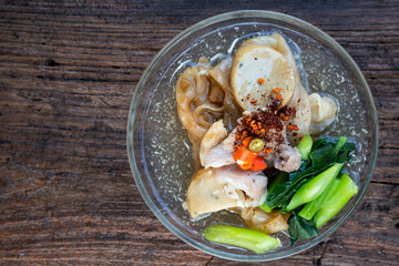 Thai food named Radna on the plate at the old wooden table