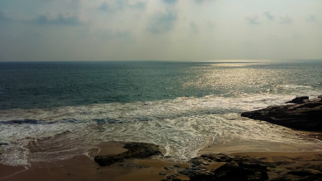 image of Azhimala Beach in Trivandrum, India. Arabian sea and rocky shores.