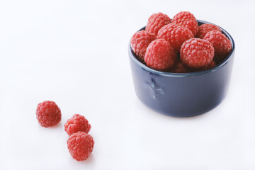 Ripe raspberries on a white background