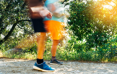Unfocused hikers walking down the mountain. Moving shot of two hikers on the mountain. Mountain sport concept.
