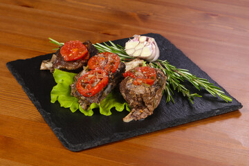 Baked elk meat with tomatoes