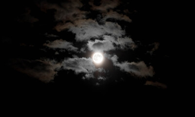 Fototapeta na wymiar Full moon and lots of clouds. Close up. Night shot