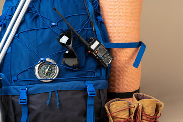 Blue backpack and hiking boots. Mountain gear close up