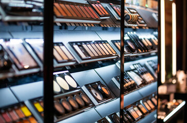 Set of cosmetics on shelves in beauty store - obrazy, fototapety, plakaty