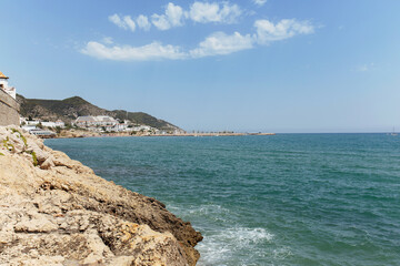 Seascape with mountains and blue sky at background in Catalonia, Spain