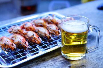 Grilled shrimp (Giant freshwater River prawn) grilling with charcoal at home, Natural Light in the evening with Beer. Bangkok, Thailand