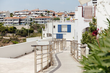 Selective focus of walkway with railing on urban street with houses in Catalonia, Spain