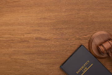top view of bankruptcy law book and gavel on wooden background