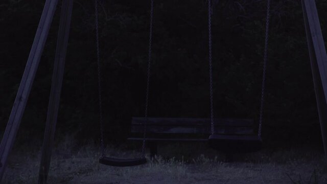 Spooky scary swing set moving in the dark, 4K, UHD, Zoutelande, Zeeland, Netherlands, Holland, 4K, UHD
