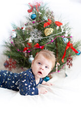 infant near christmas tree new year