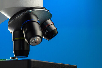 Fototapeta na wymiar Close up photo of a microscope lenses examining glass sample