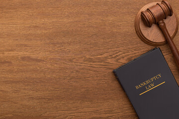 top view of bankruptcy law book and gavel on wooden background