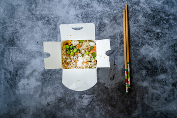 Take Out Chinese Rice with Green Peas and Almond in Plastic Box Package and Chopsticks / Street Food.