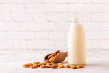 A bottle of almond milk and almonds