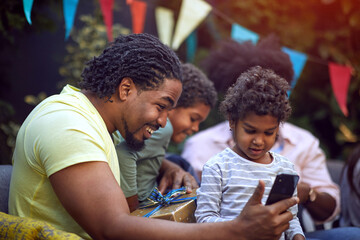 afro-american family with childs at birthday party have fun and making selfie.