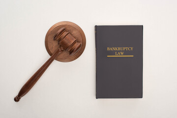 top view of bankruptcy law book and gavel on white background