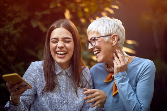 Happy Daughter And Her Senior Mother Have Fun Together Outdoor At Home.