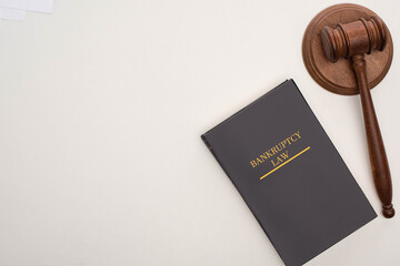top view of bankruptcy law book and gavel on white background
