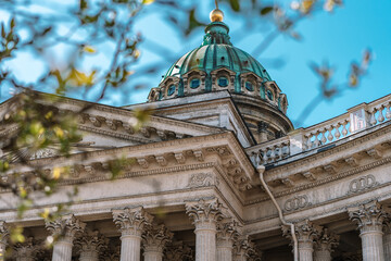 Kazan Cathedral on a Sunny summer day, a beautiful green Bush on the side and the glare of the sun...