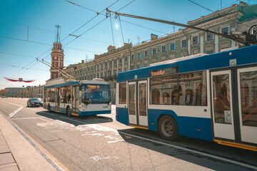 Fototapeta na wymiar Trolleybuses travel through the streets of St. Petersburg in the city center on a summer day