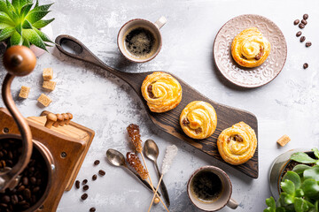 Fresh pastry sweet swirl buns with raisins on wooden board for breakfast or brunch and coffee. Party food concept. Top view.