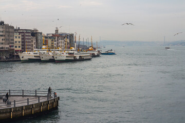 Fototapeta premium Ferries on the pier at rainy weather in Istanbul. Turkey