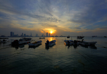Fishing boats against Bharain skyline during sunset, HDR image
