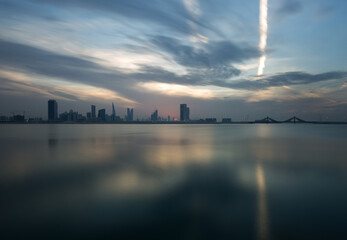 Fototapeta premium Bahrain skyline at sunset with dramatic clouds